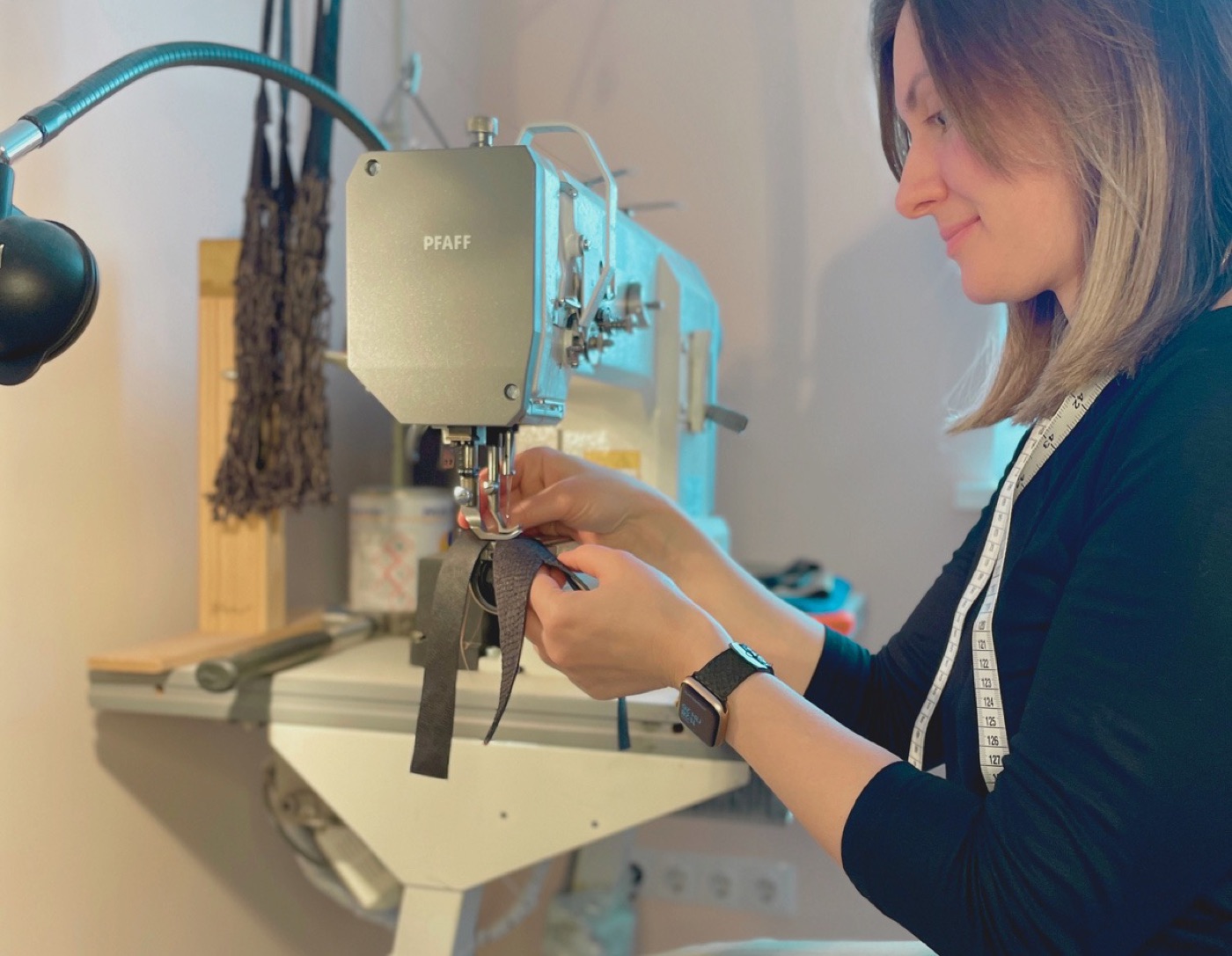 Yuliia Buhlak stitching salmon leather at the sewing machine in the Fiskin atelier